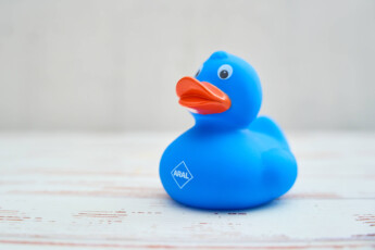 Augsburg, Bavaria, Germany – April 17, 2024: Blue rubber duck with ARAL logo. Promotional gift *** Blaue Badeente mit AR