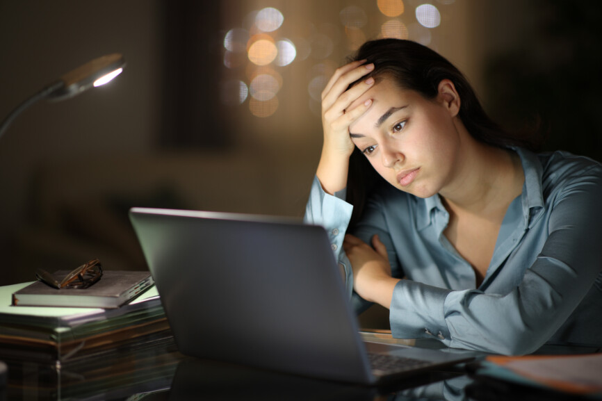 Worried tele worker checking laptop in the night